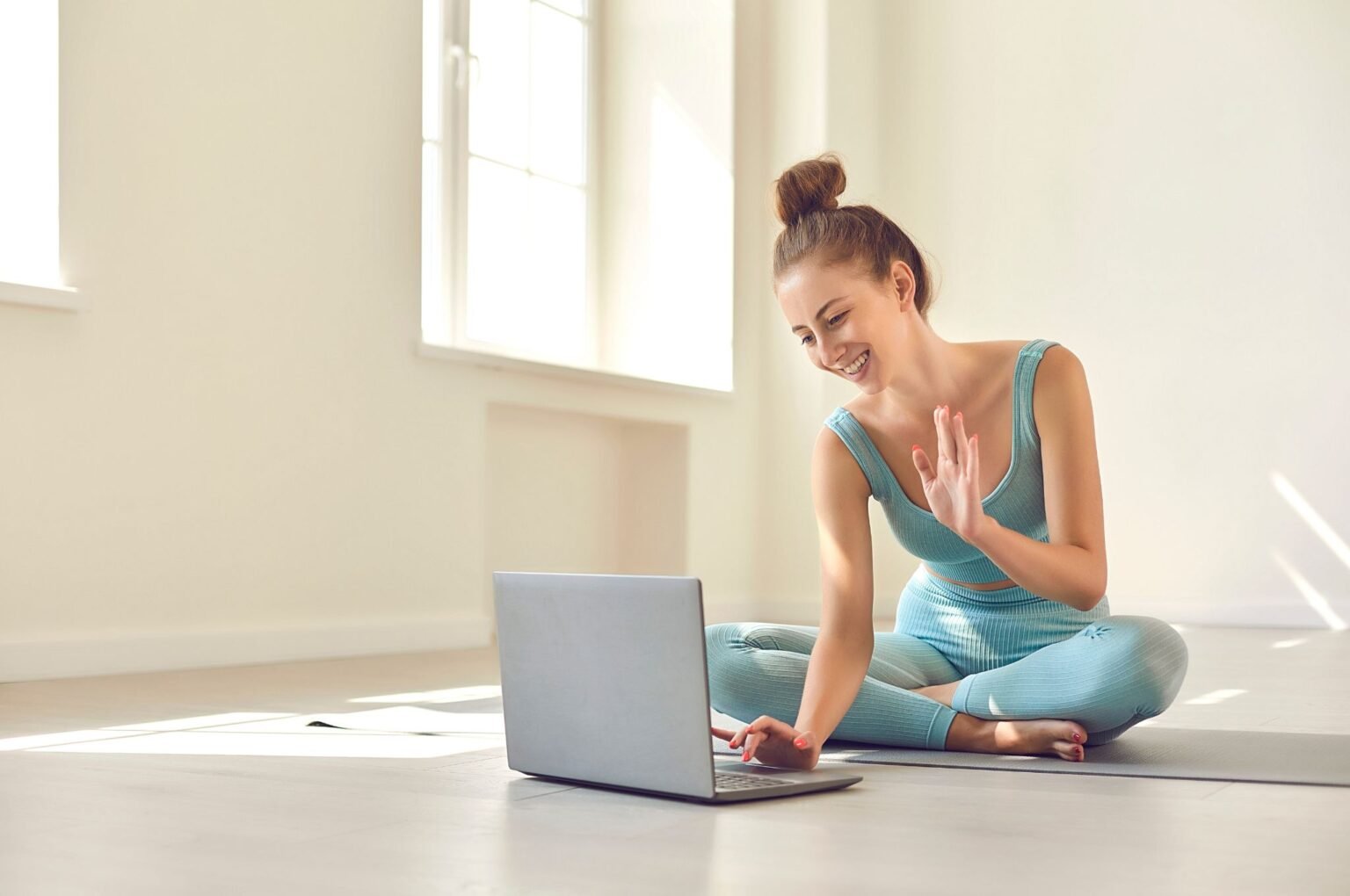 Professionista nel mondo del fitness che sta svolgendo una seduta di allenamento da remoto tramite un video corso.